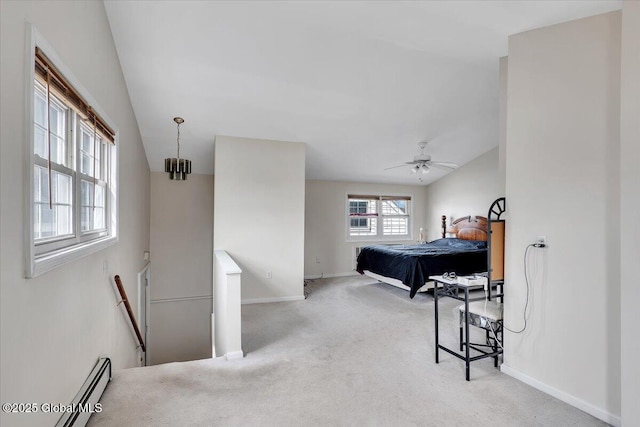 carpeted bedroom with a baseboard heating unit, vaulted ceiling, a ceiling fan, and baseboards