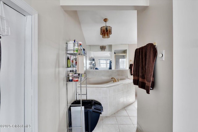 full bathroom featuring tile patterned floors, a bath, and a shower stall