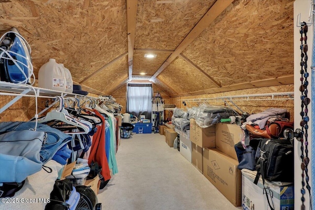 walk in closet featuring vaulted ceiling and carpet floors