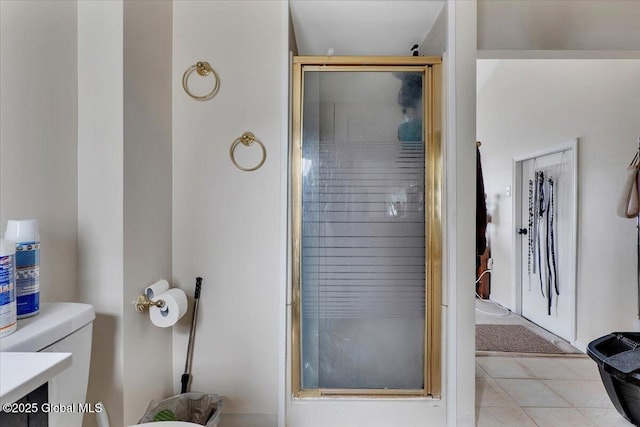 full bathroom with tile patterned flooring, toilet, and a stall shower