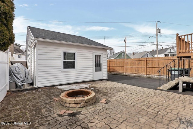 view of patio / terrace featuring a playground, a fenced backyard, and a fire pit