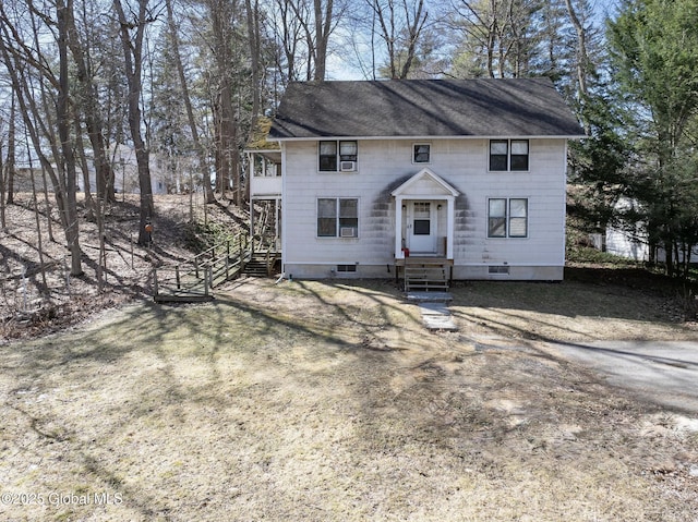 colonial home featuring crawl space, roof with shingles, and entry steps