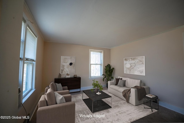 living room featuring crown molding and baseboards