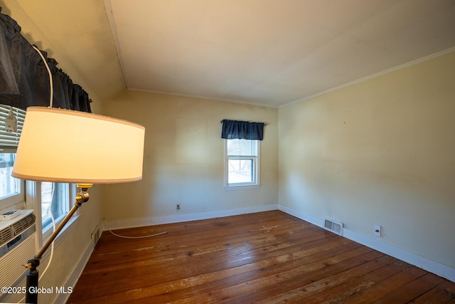 interior space with visible vents, crown molding, baseboards, and hardwood / wood-style floors