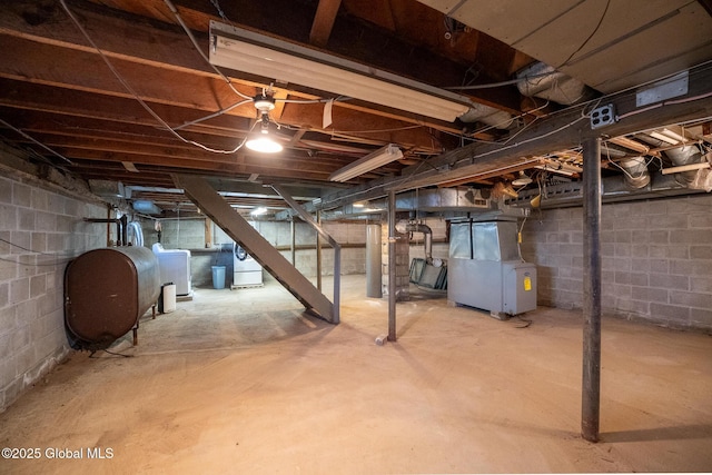 unfinished basement featuring heating unit and heating fuel