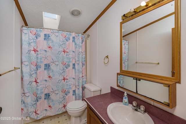 bathroom with tile patterned floors, toilet, a textured ceiling, a skylight, and vanity