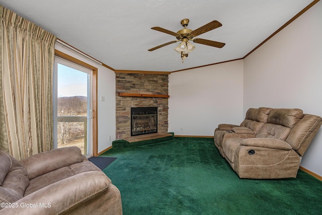 carpeted living area featuring a stone fireplace, crown molding, baseboards, and ceiling fan