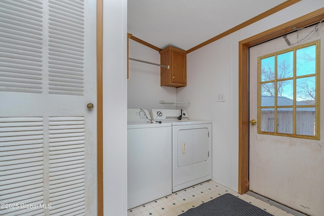 laundry area featuring cabinet space, separate washer and dryer, light floors, and crown molding