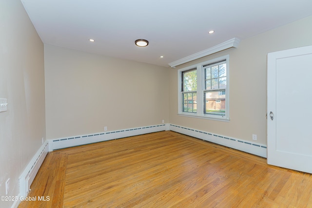 empty room featuring recessed lighting, baseboard heating, and light wood-style flooring