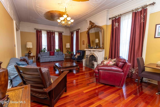 47 Church St, Amsterdam, NY 12010 - living area featuring an inviting chandelier, crown molding, a fireplace, and wood finished floors