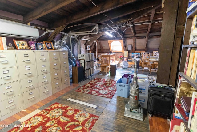 47 Church St, Amsterdam, NY 12010 - below grade area with a wall mounted AC and wood finished floors