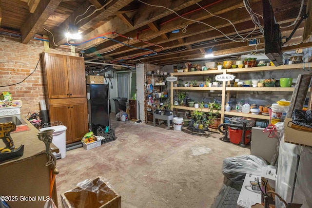 47 Church St, Amsterdam, NY 12010 - unfinished below grade area featuring freestanding refrigerator and brick wall