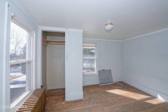 unfurnished bedroom with wood-type flooring and ornamental molding