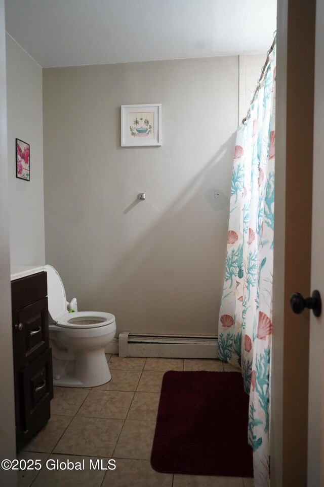 full bath with tile patterned flooring, a baseboard heating unit, toilet, a shower with curtain, and vanity