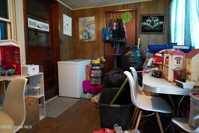 laundry room with wood walls