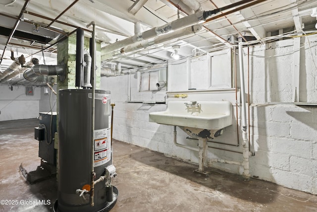 unfinished basement featuring water heater and a sink