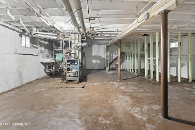 unfinished basement featuring water heater