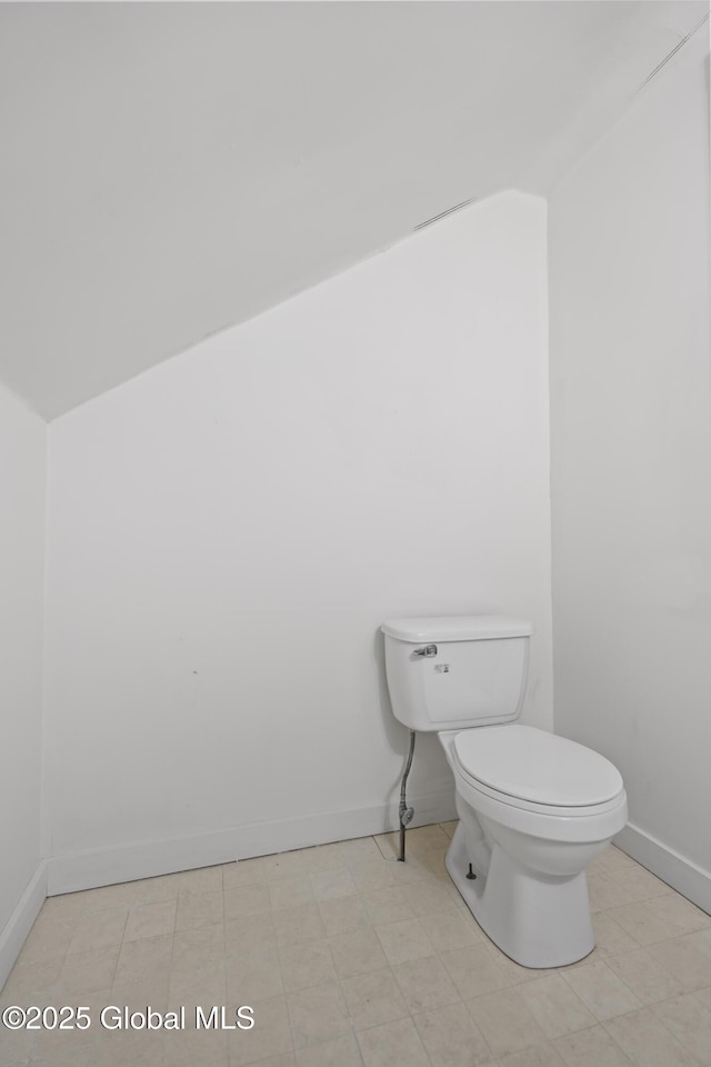 bathroom with toilet and baseboards