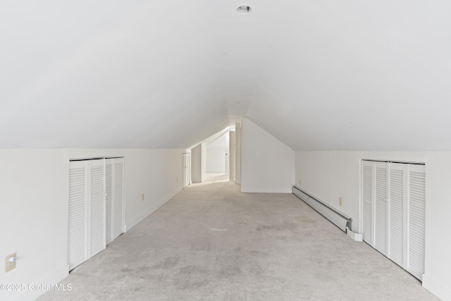 bonus room featuring vaulted ceiling, baseboard heating, and carpet floors