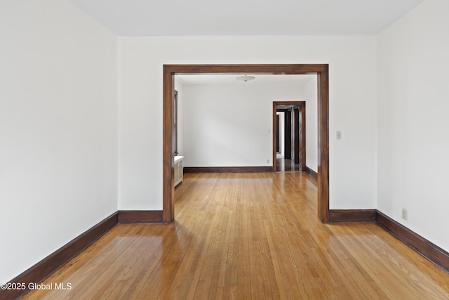 empty room featuring light wood-style floors and baseboards