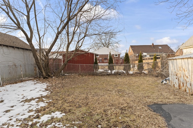 view of yard with an outbuilding and fence