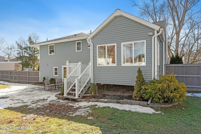 back of property featuring a patio and fence