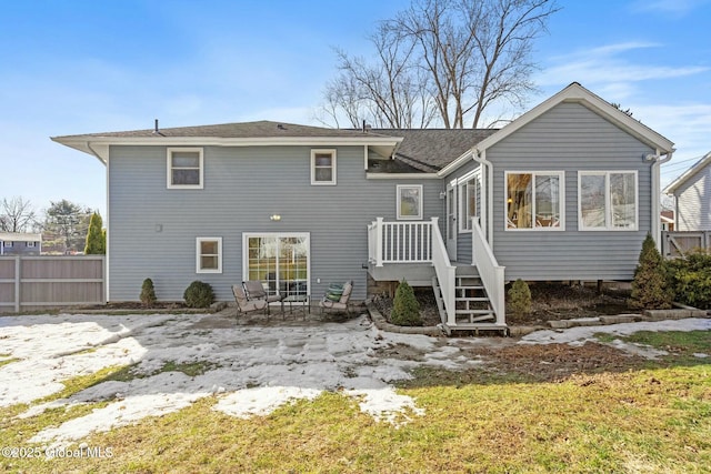 rear view of house featuring a patio area and fence