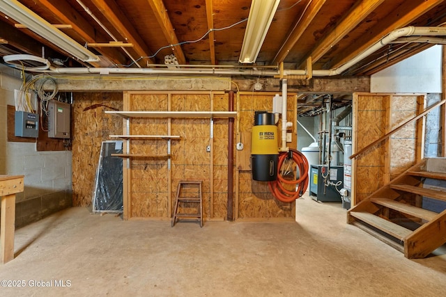 unfinished basement featuring stairway and electric panel