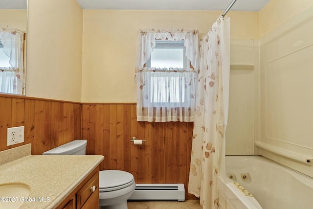 bathroom featuring vanity, tile patterned flooring, wainscoting, toilet, and baseboard heating