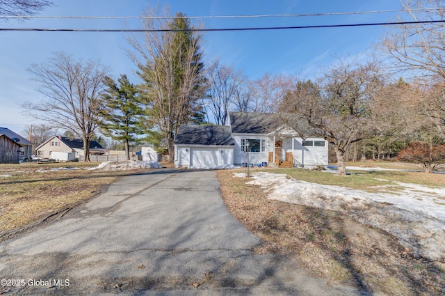 view of front of property featuring aphalt driveway and a garage