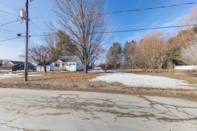 view of yard featuring driveway and a garage