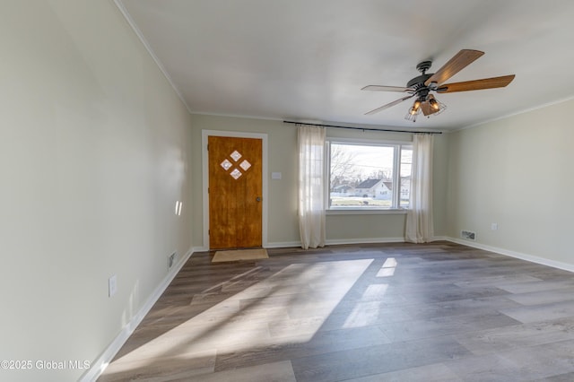 foyer featuring crown molding, wood finished floors, and baseboards