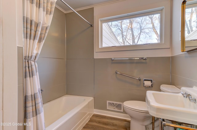 full bathroom featuring toilet, visible vents, a wealth of natural light, and a sink