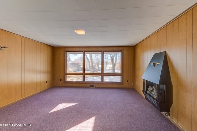 unfurnished living room with carpet flooring and visible vents