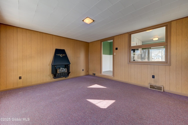 carpeted empty room featuring visible vents and baseboards