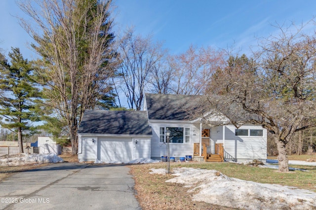 view of front of house featuring aphalt driveway and an attached garage