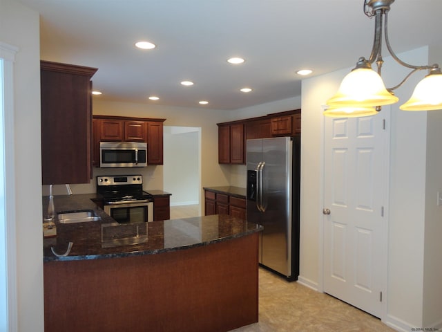 kitchen with recessed lighting, appliances with stainless steel finishes, a peninsula, and a sink