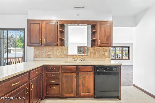 kitchen featuring visible vents, a sink, open shelves, black dishwasher, and light countertops