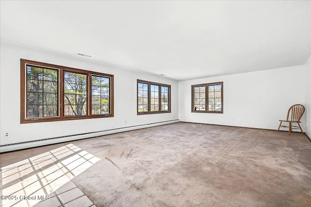 carpeted empty room featuring a baseboard radiator