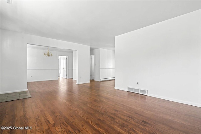 unfurnished living room featuring baseboards, visible vents, a baseboard radiator, dark wood finished floors, and a chandelier