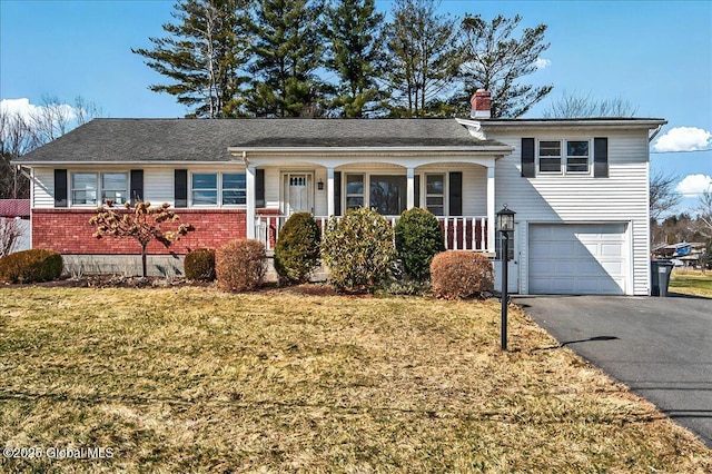 split level home with brick siding, an attached garage, covered porch, a chimney, and driveway