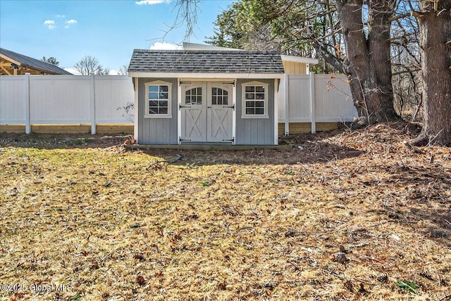 view of shed featuring fence