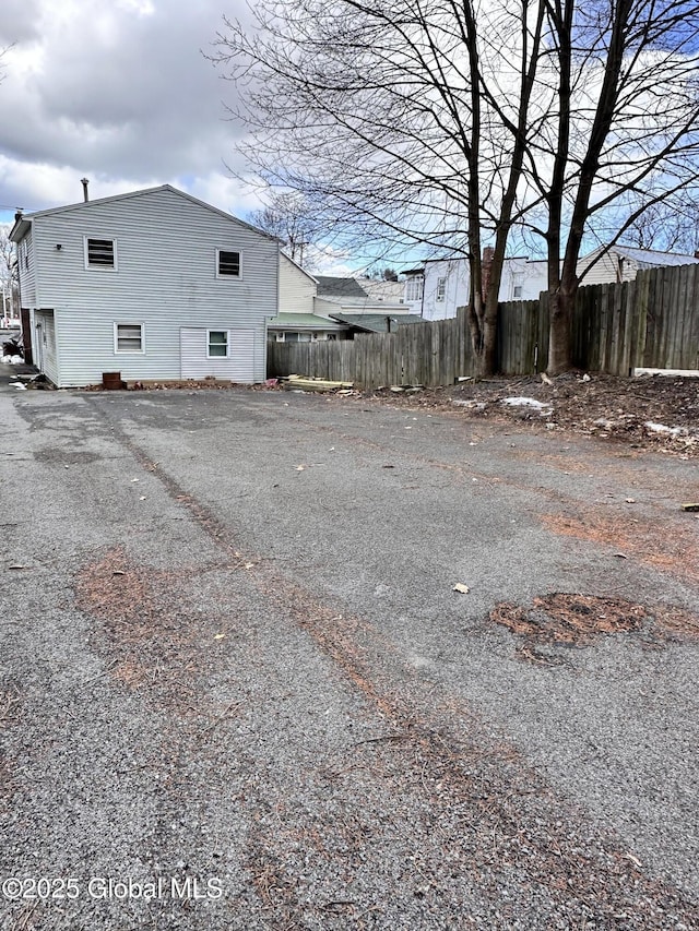 view of home's exterior featuring fence