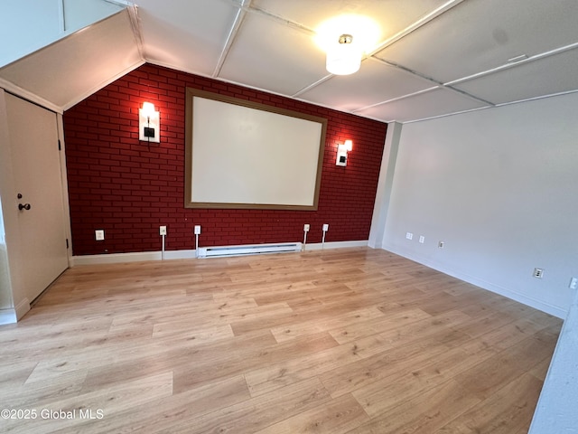 1 S Main St, Voorheesville, NY 12186 - home theater room featuring brick wall, baseboard heating, light wood-style flooring, and vaulted ceiling