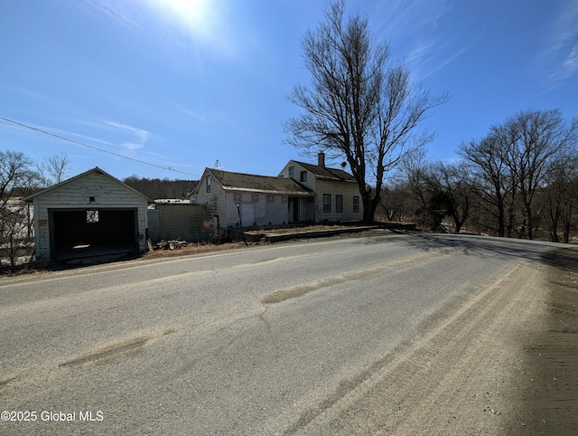 exterior space featuring an outbuilding, driveway, and a detached garage