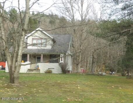 view of front of property with covered porch and a front yard