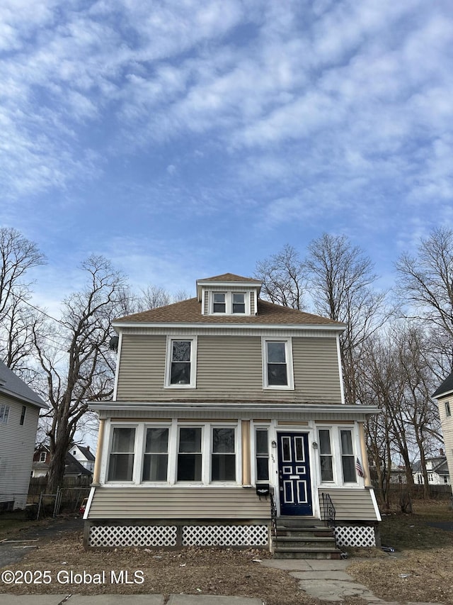 traditional style home with entry steps and roof with shingles