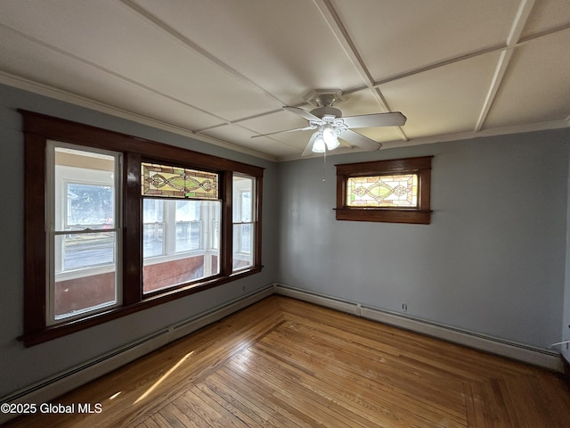 unfurnished room with a baseboard heating unit, crown molding, wood finished floors, and ceiling fan