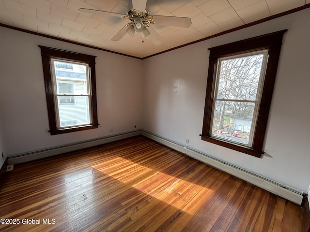 unfurnished room with baseboards, a baseboard radiator, ceiling fan, ornamental molding, and hardwood / wood-style flooring