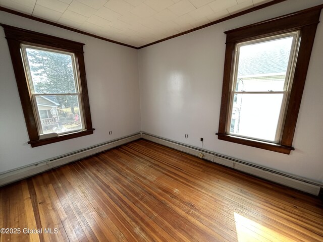 unfurnished room featuring wood-type flooring and ornamental molding